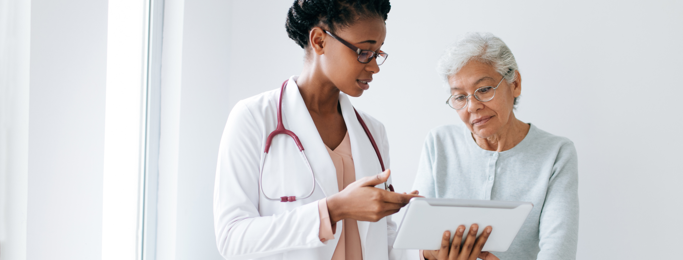 Primary Care Provider sharing results of a digital cognitive assessment featuring a clock drawing test with their patient