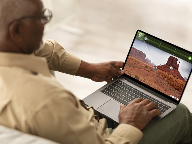 older man playing a brain game on his laptop