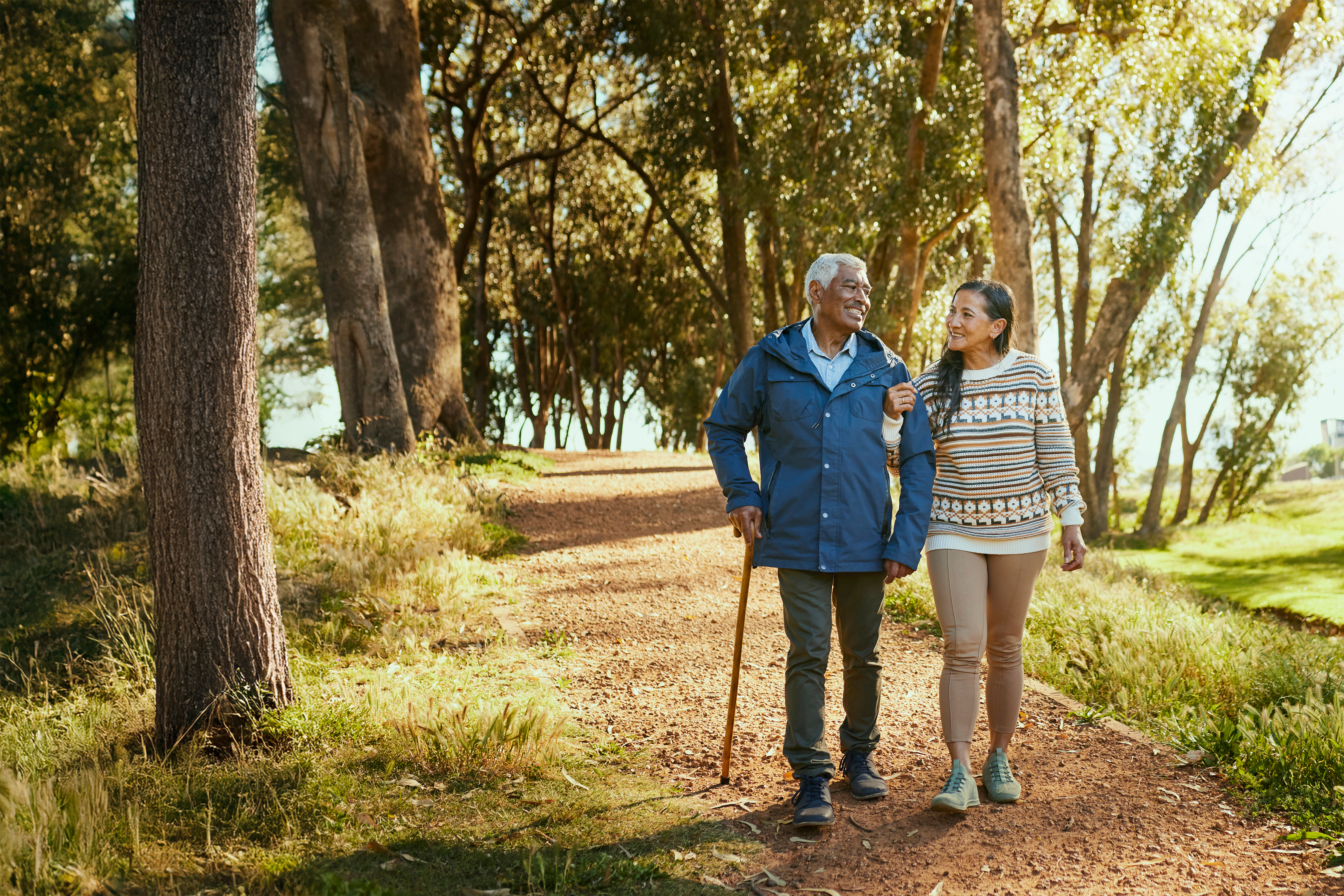 Elderly couple taking a walk in the park-hero