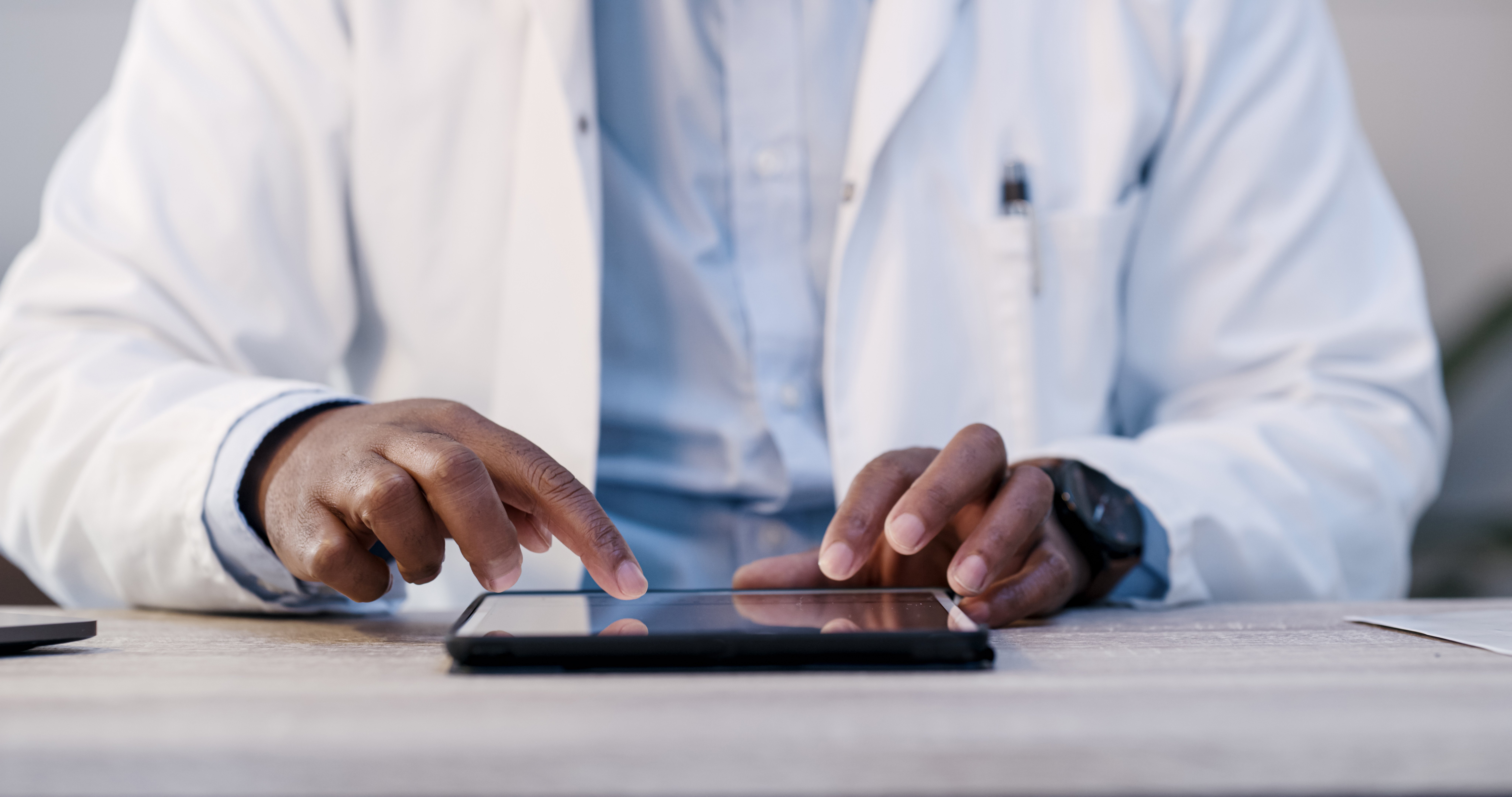 Male doctor using digital tablet in office